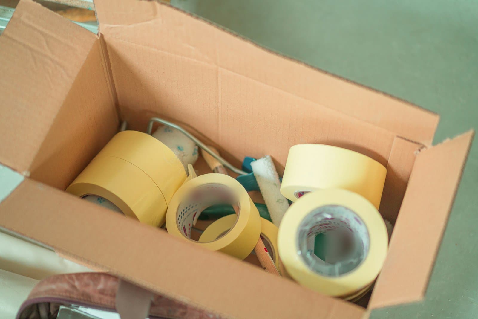 Open cardboard box with rolls of packing tape